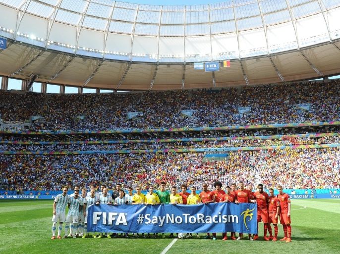 BRASILIA, BRAZIL - JULY 05: Players from both sides hold up a Say No to Racism banner ahead of the 2014 FIFA World Cup Brazil Quarter Final match between Argentina and Belgium at Estadio Nacional on July 05, 2014 in Brasilia, Brazil.
