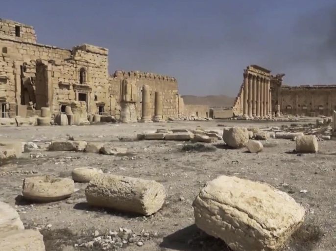 In this image made from a militant video posted on YouTube on Tuesday, May 26, 2015, which has been verified and is consistent with other AP reporting, smoke rises behind archaeological ruins in Palmyra, Syria. The video released by a media arm of the Islamic State group purportedly showed the archaeological ruins of Palmyra apparently undamaged. (Militant video via AP)