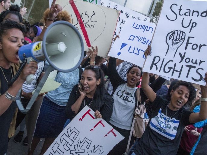 Israelis from the Ethiopian community take part in a protest against alleged police brutality and institutionalised discrimination in the city of Haifa, on May 12, 2015. More than 135,000 Ethiopian Jews live in Israel, having immigrated to the Jewish state in two waves in 1984 and 1991. AFP PHOTO / JACK GUEZ