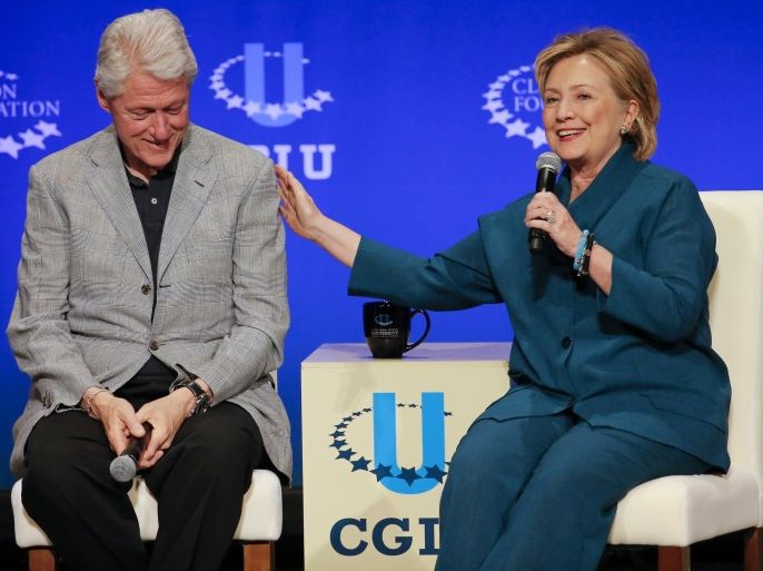 FILE - In this March 22, 2014, file photo, former President Bill Clinton, left, listens as former Secretary of State Hillary Rodham Clinton speaks during a student conference for the Clinton Global Initiative University at Arizona State University in Tempe, Ariz. Clinton had long ago moved on from her bruising defeat in her 2008 presidential run. Clinton questioned whether the country was willing to give her family the White House for the third time. A less talked about concern was health, both hers and her husbands. The former president had undergone quadruple bypass surgery and had to make drastic lifestyle changes. Hillary Clinton would be 69 years old on Election Day, tying Ronald Reagan as the oldest American to be elected president if she won. (AP Photo/Matt York, File)