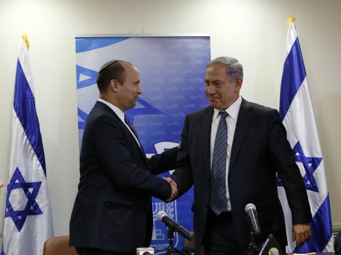 Israeli Prime Minister Benjamin Netanyahu (R) shakes hands with the head of the right-wing Jewish Home party, Naftali Bennett as they arrive to give a press conference at the Knesset in Jerusalem, on May 6, 2015, to announce the formation of a coalition government. Just ahead of the midnight deadline, Netanyahu managed to put together a narrow majority coalition, comprising his rightwing Likud party with centre-right Kulanu, far-right national-religious Jewish Home and two ultra-Orthodox parties, United Torah Judaism (UTJ) and Shas. AFP PHOTO / GALI TIBBON