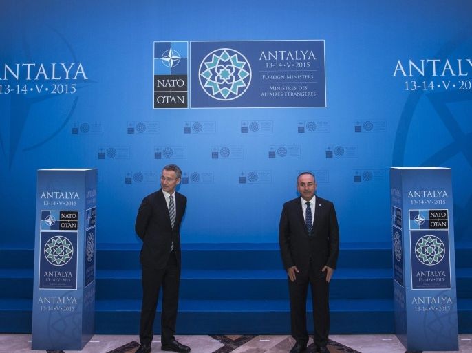 Nato Secretary General Jens Stoltenberg (L) and Turkish Foreign Minister Mevlut Cavusoglu (R) wait for family photo at the NATO Foreign Ministers Summit in Antalya, Turkey, 13 May 2015. NATO foreign ministers will gather to discuss a range of topics at the summit taking place 13 to 14 May 2015.