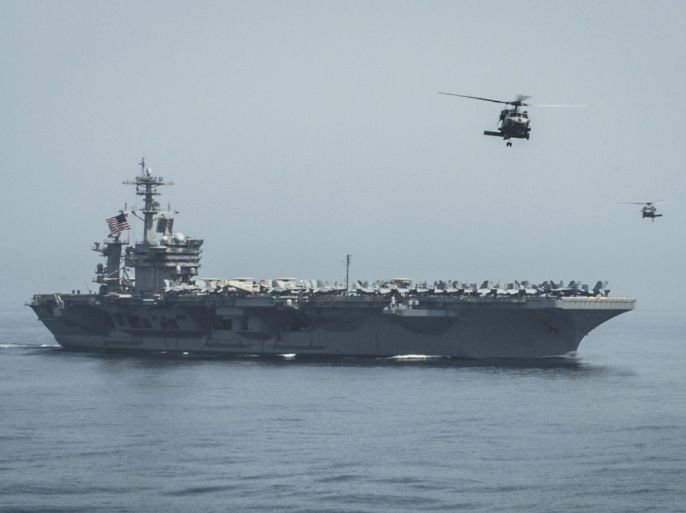 In this April 13, 2015 photo released by U.S. Navy Media Content Services, helicopters fly from the aircraft carrier USS Theodore Roosevelt during a vertical replenishment with the aircraft carrier USS Carl Vinson in the Gulf of Oman. The U.S. Navy has dispatched USS Theodore Roosevelt toward the waters off Yemen to join other American ships prepared to intercept any Iranian vessels carrying weapons to Houthi rebels, U.S. officials said on Monday. (Mass Communication Specialist 2nd Class Scott Fenaroli/ U.S. Navy Media Content Services via AP)