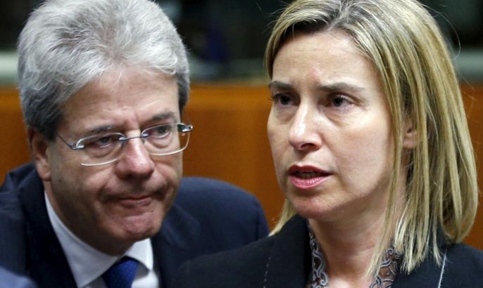 European Union foreign policy chief Federica Mogherini and Italian Foreign Minister Paolo Gentiloni (L) attend a meeting of European Union foreign and defence ministers at the EU Council in Brussels, Belgium, May 18, 2015. The EU's foreign policy chief pushed on Monday for a naval mission in the Mediterranean to target Libyans smuggling people to Europe, saying that an EU agreement would hasten the U.N. mandate that the plan needs to succeed. REUTERS/Francois Lenoir