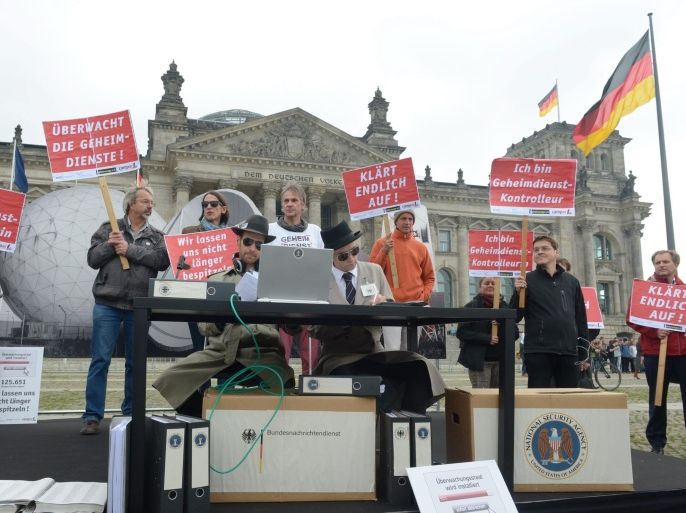 Protesters hold placards with slogans against the activities of the US National Security Agency (NSA) during a protest outside the Reichstag in Berlin, Germany, 25 September 2014. Meanwhile, a Swedish charity named fugitive US intelligence contractor Edward Snowden and British Guardian newspaper editor Alan Rusbridger honorary co-winners of the 2014 Right Livelihood Award for 'acts of civil disobedience.' Snowden, who currently has asylum in Russia, is wanted by the US government on espionage charges for exposing extensive telephone and internet data-collection programmes used by the US National Security Agency (NSA).
