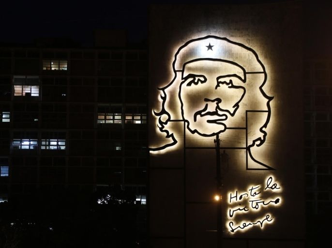 Some office lights are left on at the Ministry of Interior, decorated with an iron sculpture of Cuba's revolutionary hero Ernesto "Che" Guevara at Revolution Square in Havana, Cuba, Friday, April 10, 2015. The sculpture is by Enrique Avila Gonzalez. (AP Photo/Desmond Boylan)