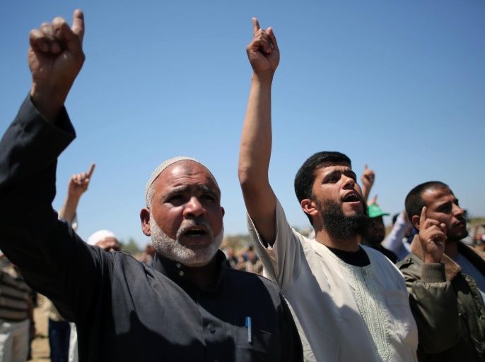 Palestinians shout slogans during a rally marking the 67th anniversary of the 'Nakba' on May 15, 2015 near the border with Israel, east of Khan Younis in the southern Gaza Strip. 'Nakba' means in Arabic 'catastrophe' in reference to the birth of the state of Israel 67-years-ago in British-mandate Palestine, which led to the displacement of hundreds of thousands of Palestinians who either fled or were driven out of their homes during the 1948 war over Israel's creation. AFP PHOTO / SAID KHATIB