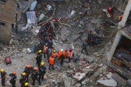 Members of a rescue team from Hungary and Nepal armed police personnel search for earthquake survivors under the debris of a collapsed building, in Kathmandu, Nepal April 30, 2015. REUTERS/Adnan Abidi