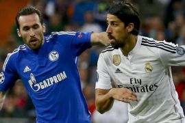 Real Madrid's German midfielder Sami Khedira (R) duels for the ball with Schalke 04's Austrian midfielder Christian Fuchs (L) during the UEFA Champions League round 16 second leg soccer match played at the Santiago Bernabeu stadium in Madrid, Spain, 10 March 2015.