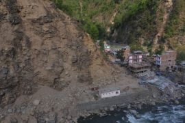 In this aerial photograph on May 14, 2015, collapsed structures are seen that were hit by a earthquake-triggered landslide on May 12 in a small town of Singati in northeastern Nepal. Two strong earthquakes struck Nepal killing over 8,000 people and leaving hundreds of thousands homeless within a period of three weeks. AFP PHOTO / PRAKASH MATHEMA