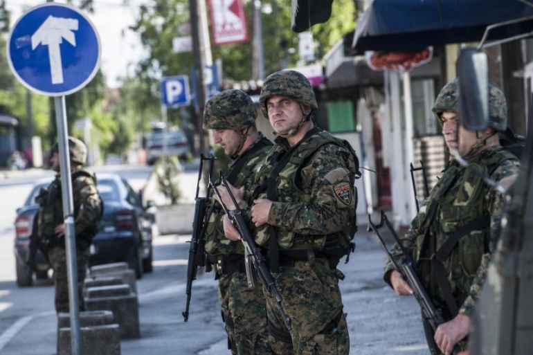 Macedonian police officers patrol in a street in the town of Kumanovo on May 10, 2015. Shooting broke out for a second day on May 10 in north Macedonia as concern mounted in Europe after clashes between police and unidentified gunmen that erupted on May 9 at dawn in the restive north of Macedonia. Eight policemen and 14 gunmen have been killed in two days of clashes, police said on Sunday. AFP PHOTO/ARMEND NIMANI