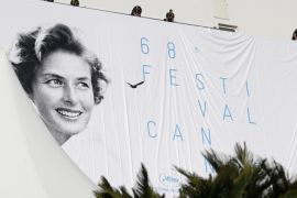 Workers set up the official poster of the 68th annual Cannes Film Festival on the Palais des Festivals facade, in Cannes, France, 11 May 2015. The poster displays a photograph of Swedish actress Ingrid Bergman taken by Polish photographer David Seymour. The film festival will run from 13 to 24 May.