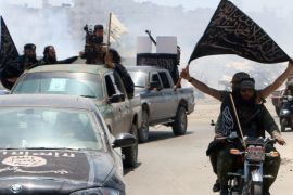 Fighters from Al-Qaeda's Syrian affiliate Al-Nusra Front drive in the northern Syrian city of Aleppo flying Islamist flags as they head to a frontline, on May 26, 2015. Once Syria's economic powerhouse, Aleppo has been divided between government control in the city's west and rebel control in the east since shortly after fighting there began in mid-2012. AFP PHOTO / AMC / FADI AL-HALABI