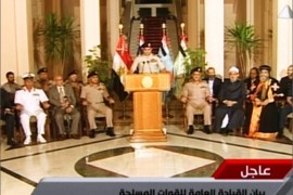 An image grab taken from Egyptian state TV shows Egyptian Defence Minister Abdelfatah al-Sissi delivering a statement as opposition leader Mohamed ElBaradei (L), the heads of the Coptic Church and Al-Azhar -- Sunni Islam's highest seat of learning and other officials sit next to him on July 3, 2013 during the unveiling of a roadmap for Egypt's political future, with state media reporting that the plan sets a tight schedule for new elections. A top aide to Egypt's President Mohamed Morsi slammed what he called a "military coup" as an army ultimatum passed and the security forces slapped a travel ban on the Islamist leader AFP PHOTO/EGYPTIAN TV == RESTRICTED TO EDITORIAL USE - MANDATORY CREDIT "AFP PHOTO / EGYPTIAN TV" - NO MARKETING NO ADVERTISING CAMPAIGNS - DISTRIBUTED AS A SERVICE TO CLIENTS ===