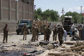 KABUL, AFGHANISTAN - MAY 17: US and afghan security forces inspect the site of a suicide attack in Kabul on May 17, 2015. At least three people, including a foreign national, were killed and 20 others were wounded after a suicide bomber detonated his explosives near the military wing of Kabul International Airport on Sunday, Afghani police said.