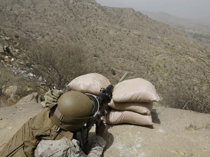 A Saudi soldier aims his weapon from behind a sandbag barricade at the border with Yemen in Jazan, Saudi Arabia, Monday, April 20, 2015. The Saudi air campaign in Yemen is now in its fourth week. (AP Photo/Hasan Jamali)