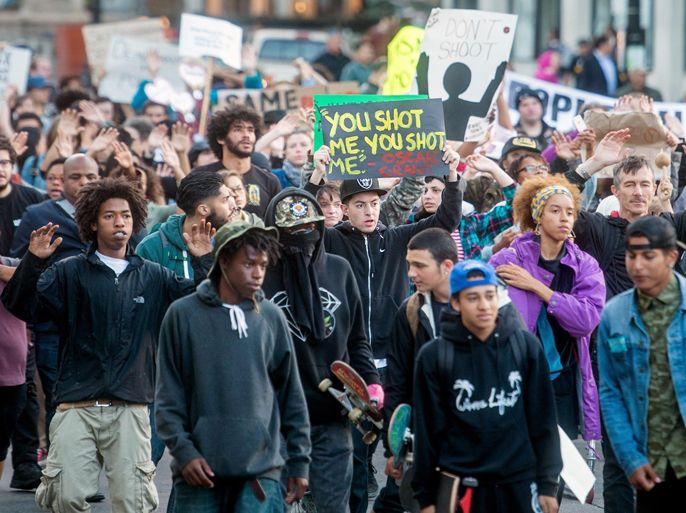 FILE - This Aug. 20, 2014 file photo several hundred demonstrators march through Oakland, Calif. protesting the police shooting of unarmed black 18-year old Michael Brown in Ferguson, Mo. The San Francisco Bay Area's three largest police unions publish an "open letter" saying recent the anti-police rhetoric demonstrations have reached dangerous levels. (AP Photo/Noah Berger, file)