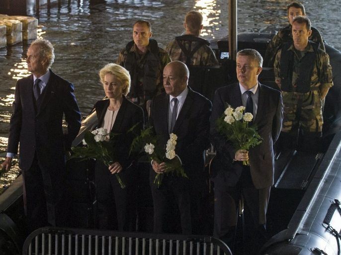 A handout picture provided French Army Communications Audiovisual office (ECPAD) shows (L-R) Spanish Defense Minister Pedro Morenes, German Defense Minister Ursula von der Leyen, French Defense Minister Jean-Yves Le Drian, and Polish Defense Minister Tomasz Siemoniak throw flowers from a French military boat under a submarine bunker to commemorate the 70th anniversary of the defeat of the Lorient German resistance pocket, in Lorient, France, 10 May 2015. In WWII, the city of Lorient was occupied by Nazi German troops, who resisted Allied Forces by taking shelter in the heavily protective submarine bunker. EPA/ARNAUD KARAGHEZIAN/ECPAD/HANDOUT