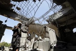 A member of Houthi militia inspects a house which was allegedly destroyed by an airstrike of the Saudi-led coalition in Sanaa, Yemen, 11 May 2015. The Saudi-led coalition and the Houthis, which have been fighting for nearly two months, reached a five-day temporary humanitarian truce, set to begin on 12 May at 11 pm (2000 GMT).