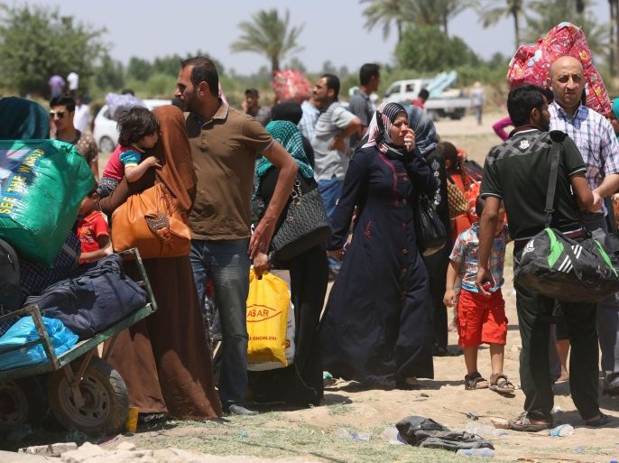 In this Saturday, May 16, 2015 photo, Iraqis fleeing from their hometown of Ramadi, Iraq, rest near the Bzebiz bridge, 65 kilometers (40 miles) west of Baghdad. The Islamic State group seized control of the city of Ramadi on Sunday, sending Iraqi forces racing out of the city in a major loss despite the support of U.S.-led airstrikes targeting the extremists. (AP Photo/Hadi Mizban)
