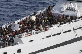 Rescued migrants are seen aboard the Monte Sperone ship of the Italian border police in the Mediterranean Sea, heading to the Island of Lampedusa, southern Italy, Thursday, May 14, 2015. The Monte Sperone takes part in the Frontex's Triton Operation patrolling waters off Italy. Triton currently has 10 patrol vessels, three offshore patrol ships, three aircraft and two helicopters at its disposal. (AP Photo/Antonio Calanni)