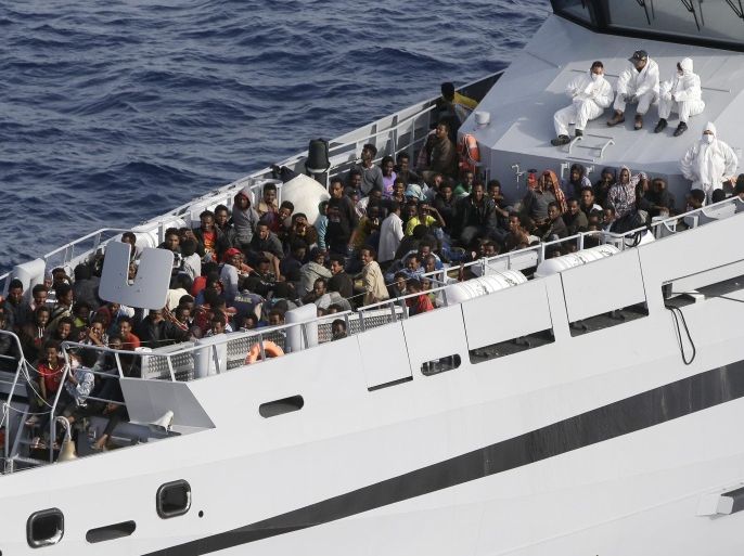 Rescued migrants are seen aboard the Monte Sperone ship of the Italian border police in the Mediterranean Sea, heading to the Island of Lampedusa, southern Italy, Thursday, May 14, 2015. The Monte Sperone takes part in the Frontex's Triton Operation patrolling waters off Italy. Triton currently has 10 patrol vessels, three offshore patrol ships, three aircraft and two helicopters at its disposal. (AP Photo/Antonio Calanni)