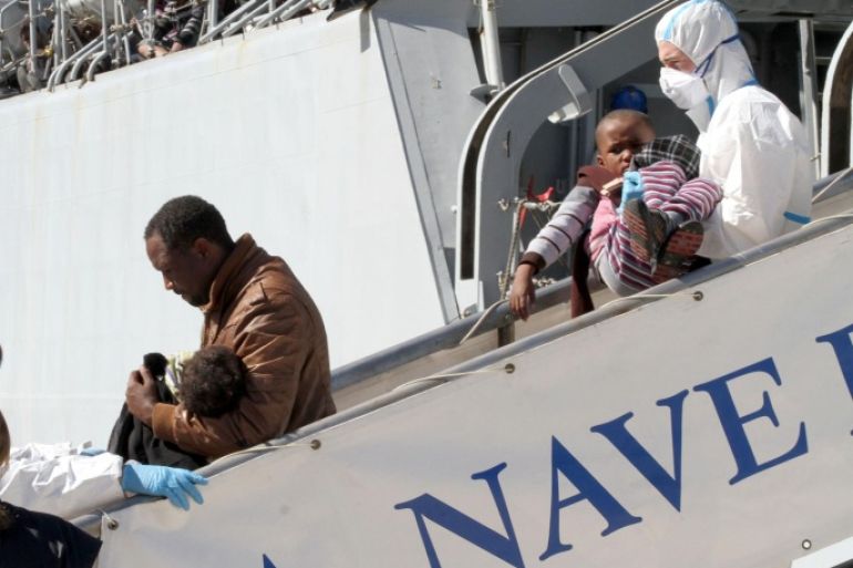 Migrants disembark from the Italian Navy frigate Bersagliere at the Reggio Calabria harbor, Italy, Monday, May 4, 2015. Italy's Coast Guard and Navy as well as tugs and other commercial vessels joined forces to rescue migrants in at least 16 boats Sunday, saving hundreds of them and recovering 10 bodies off Libya's coast, as smugglers took advantage of calm seas to send packed vessels across the Mediterranean. Sunday's drama at sea came a day after 3,690 migrants were saved from smugglers' boats. Most of those migrants are still being taken to southern Italian ports even as the fresh rescues were taking place. (AP Photo/Adriana Sapone)