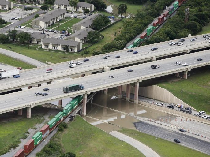 North and south bound Loop 12 at Interstate 30 is shutdown due to high water on the roadway, Friday, May 29, 2015, in Dallas. Floodwaters submerged Texas highways and threatened more homes Friday after another round of heavy rain added to the damage inflicted by storms. (AP Photo/Brandon Wade)