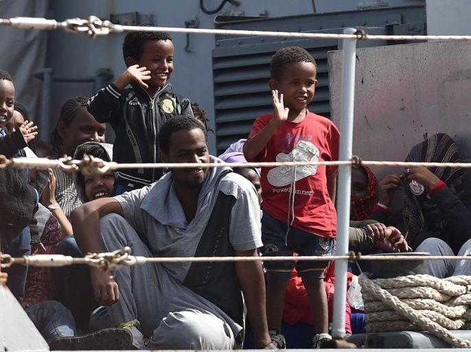 Migrants wait to disembark from the Italian Navy corvette Sfinge at the Augusta harbor, near Siracusa, Sicily, Italy, Thursday, May 21, 2015. (AP Photo/Carmelo Imbesi)