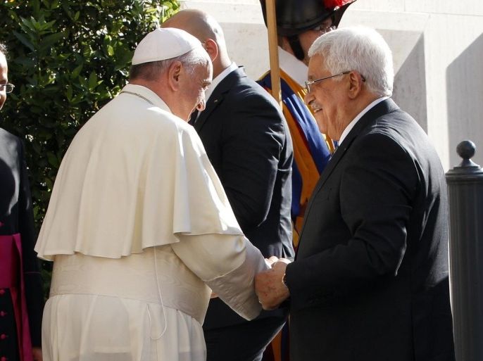 Pope Francis welcomes Palestinian President Mahmoud Abbas, right, as he arrives at the Vatican, Sunday, June 8, 2014. Pope Francis waded head-first into Mideast peace-making Sunday, welcoming the Israeli and Palestinian presidents to the Vatican for an evening of peace prayers just weeks after the last round of U.S.-sponsored negotiations collapsed. (AP Photo/Riccardo De Luca, Pool)