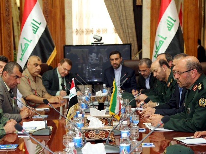 Iraqi Defence Minister Khaled al-Obeidi (L) meets with Iranian Defence Minister Hossein Dehghan (R) at the Defence Ministry in Baghdad May 18, 2015. REUTERS/Stringer