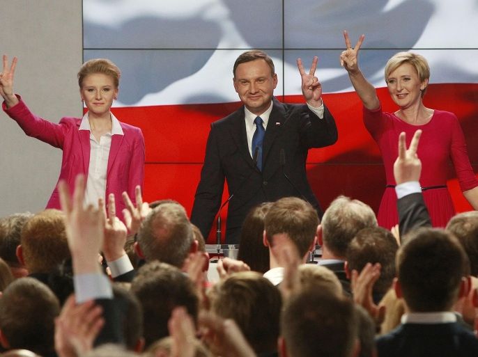 Main opposition candidate Andrzej Duda, with wife Agata,right, and daughter Kinga, left, greets supporters during his election night, as first exit polls show he won the first round of the presidential balloting, in Warsaw, Poland, Sunday, May 10, 2015.(AP Photo/Czarek Sokolowski)