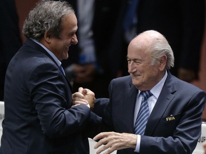 Re-elected FIFA president Sepp Blatter, right, is congratulated by FIFA vice president and UEFA president Michel Platini after his speech during the 65th FIFA Congress held at the Hallenstadion in Zurich, Switzerland, Friday, May 29, 2015. Blatter has been re-elected as FIFA president for a fifth term, chosen to lead world soccer despite separate U.S. and Swiss criminal investigations into corruption. The 209 FIFA member federations gave the 79-year-old Blatter another four-year term on Friday after Prince Ali bin al-Hussein of Jordan conceded defeat after losing 133-73 in the first round. (Patrick B. Kraemer / Keystone via AP)