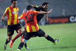 South Africa's Orlando Pirates forward Mashedi Segolela (C) vies with Esperance of Tunis players Khalil Chamam (12) and Iheb Msekni (30) during the CAF Champions League semifinal football match between South African Orlando Pirates and Esperance of Tunis, at the Olympic Stadium in Rades, near Tunis, on October 19, 2013. South African club Orlando Pirates reached the CAF Champions League final after an 18-year absence by holding Esperance 1-1 in Tunisia. AFP PHOTO/ FETHI BELAID