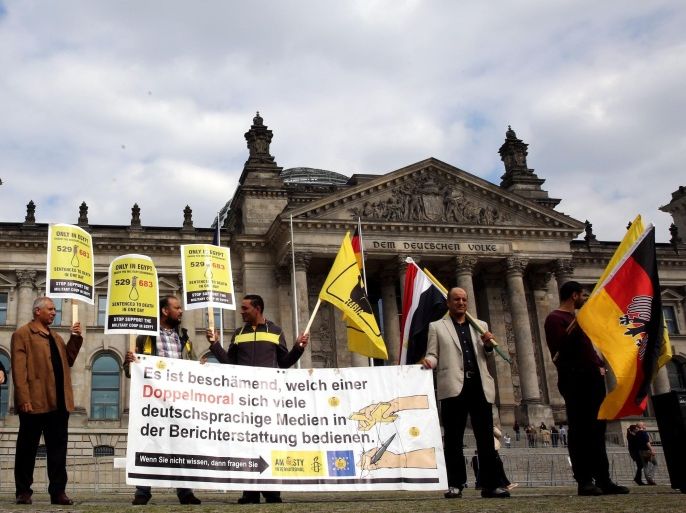 BERLIN, GERMANY - MAY 22: Egyptian demonstrators hold banners as they gather on May 22, 2015 in front of Bundestag to protest against Egyptian President Abdel Fattah el-Sisi's forthcoming visit to Germany.