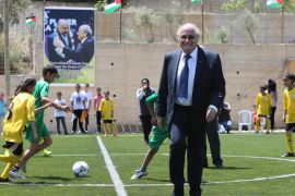 FIFA president Joseph Blatter plays football with Palestinian children during his visit to the village of Dura al-Qaraa, near the West Bank city of Ramallah, on May 20, 2015. Blatter hopes to head off a Palestinian call for a vote to expel Israel from football's governing body but that Israel must make a concession. AFP PHOTO / ABBAS MOMANI