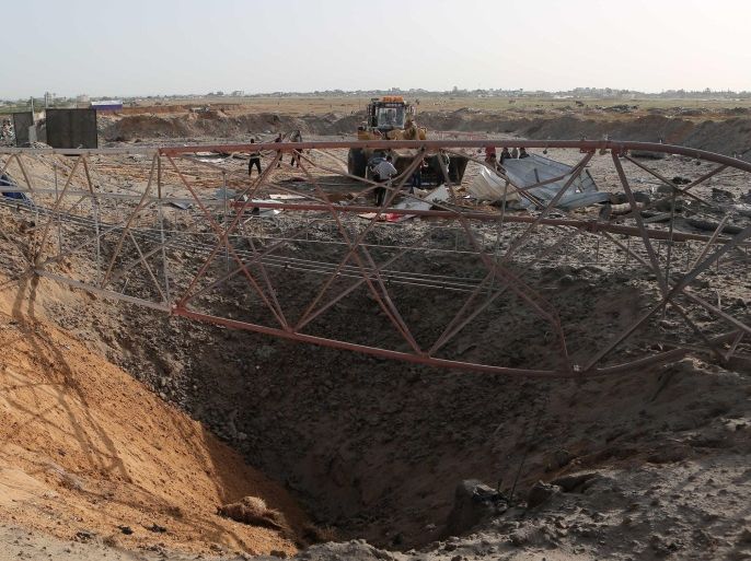 A big crater is seen on the ground following an Israeli airstrike in the southern Gaza Strip near the town of Rafah on May 27,2015. The Israeli air force carried out four strikes on militant targets in the Gaza Strip early today, Palestinian eyewitnesses said, hours after a cross-border rocket attack on the Jewish state. The planes targeted training camps belonging to the Islamic Jihad in Rafah, Khan Yunis and Gaza City, the witnesses said. There were no immediate reports of casualties. AFP PHOTO/ SAID KHATIB
