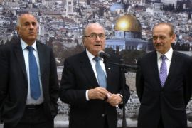FIFA President Sepp Blatter (C) speaks as President of the Palestinian Football Federation Jibril Rajoub (L) and Yasser Abed Rabbo (R), Palestinian politician and a member of the Palestine Liberation Organization's Executive Committee, listen on, in the West Bank city of Ramallah, on July 7, 2013. Blatter is on a four-day-official visit to the Palestinian territories and Israel and neighboring Jordan during which he will notably launch football turf fields.
