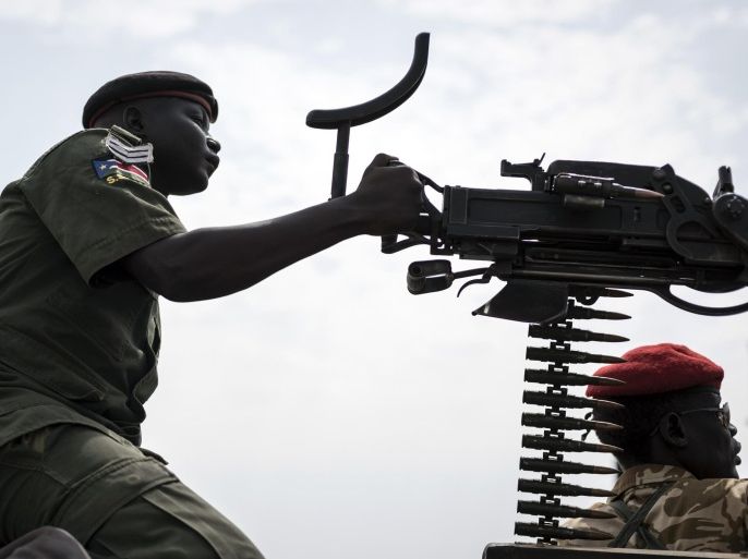 In this photo taken Tuesday, Feb. 24, 2015, a government soldier mans a vehicle-mounted machine gun in the oil-rich town of Malakal, South Sudan. Hit by falling oil revenues, South Sudan’s economy is also troubled by a violent conflict that looks set to continue and it could get worse for this young country, with the U.N. warning that South Sudan’s economy is now threatened by rampant inflation as the central bank is allegedly printing money to meet a budget shortfall. (AP Photo/Jacob Zocherman)