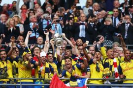 LONDON, ENGLAND - MAY 30: Per Mertesacker and Mikel Arteta of Arsenal lift the trophy in celebration after the FA Cup Final between Aston Villa and Arsenal at Wembley Stadium on May 30, 2015 in London, England. Arsenal beat Aston Villa 4-0.