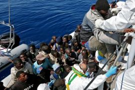 In this photo made available Thursday, April 23, 2015, members of an an Italian Financial Police unit rescue migrants off the Libyan coast after approaching an inflatable dinghy crowded with them, in the Mediterranean Sea, Wednesday, April 22, 2015. European Union leaders gathering for an extraordinary summit are facing calls from all sides to take emergency action to save lives in the Mediterranean, where hundreds of migrants are missing and feared drowned in recent days. (Alessandro Di Meo/ANSA via AP Photo) ITALY OUT