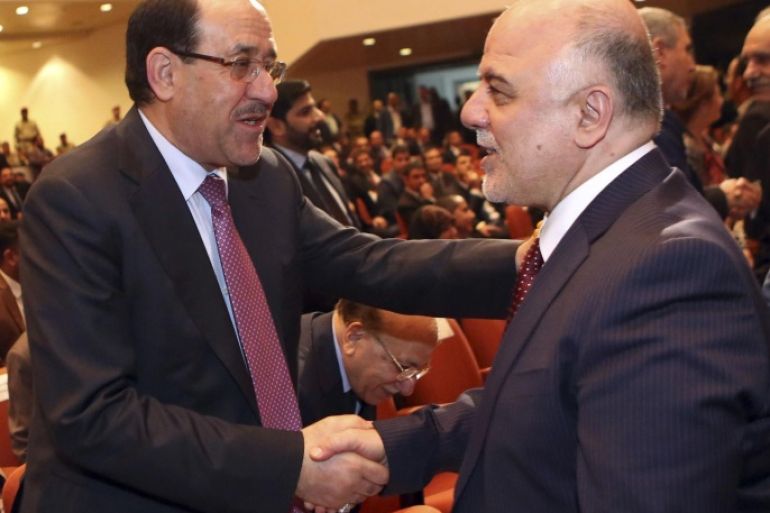 Iraq's Vice President Nouri al-Maliki (L) and new Prime Minister Haider al-Abadi shake hands during the session to approve the new government in Baghdad, September 8, 2014.Iraq's parliament approved a new government headed by Haider al-Abadi as prime minister on Monday night, in a bid to rescue Iraq from collapse, with sectarianism and Arab-Kurdish tensions on the rise. REUTERS/Hadi Mizban/Pool (IRAQ - Tags: POLITICS)