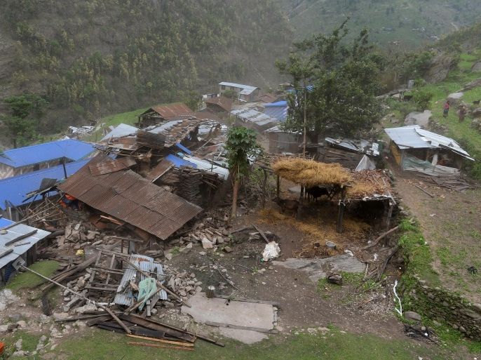 Damaged houses are seen from an Indian Army helicopter at Lapu in the Nepalese area of Gorkha on April 28, 2015. Rescuers in Nepal battled April 28, 2015 to reach remote communities devastated by a huge earthquake that has killed at least 4,349 people, as the impoverished country's leader said relief workers had still not reached many of the worst-hit areas. AFP PHOTO / SAJJAD HUSSAIN