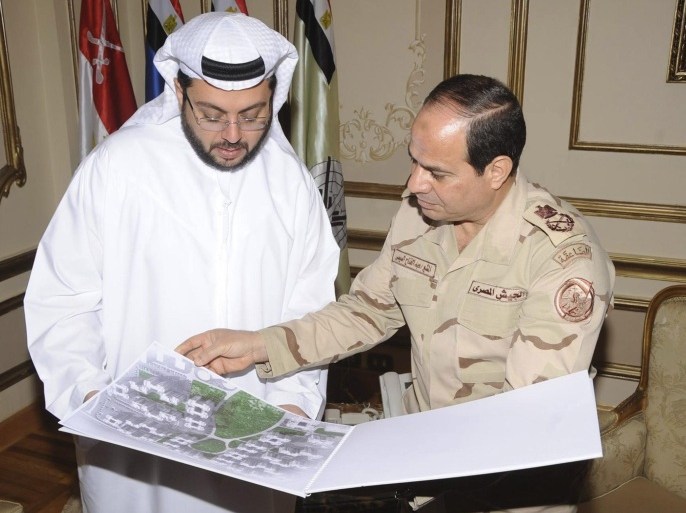 Egypt's army chief Field Marshal Abdel Fattah al-Sisi (R) looks at drawings of houses with Hasan Ismaik, Arabtec's chief executive, at the Ministry of Defence in Cairo in this March 9, 2014 handout provided by Egypt's Ministry of Defence. Arabtec Holding, Dubai's largest listed construction firm, has agreed with the Egyptian army to build one million houses in a project worth 280 billion Egyptian pounds, it said in a statement on Sunday. Picture taken March 9, 2014. REUTERS/Ministry of Defence/Handout via Reuters (EGYPT - Tags: BUSINESS CONSTRUCTION MILITARY POLITICS REAL ESTATE) ATTENTION EDITORS - THIS IMAGE HAS BEEN SUPPLIED BY A THIRD PARTY. FOR EDITORIAL USE ONLY. NOT FOR SALE FOR MARKETING OR ADVERTISING CAMPAIGNS. NO SALES. NO ARCHIVES. IT IS DISTRIBUTED, EXACTLY AS RECEIVED BY REUTERS, AS A SERVICE TO CLIENTS