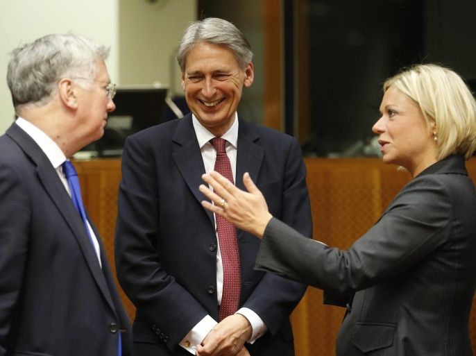 British Defence Secretary Michael Fallon, (L-R), British Foreign Secretary Philip Hammond, and Dutch Defense Minister Jeanine Hennis-Plasschaert talk prior a joint European Foreign and Defense Ministers meeting at the European Council Headquarters in Brussels, Belgium, 18 May 2015. The Middle East Peace Process is set to top the meeting's agenda.