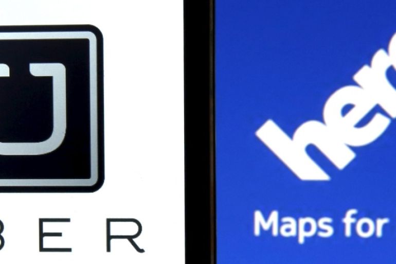 Uber logo is seen on a smartphone in front of a displayed logo of HERE, Nokia Oyj's map business, in Zenica, Bosnia and Herzegovina, in this May 8, 2015 photo illustration. Taxi service Uber has submitted a $3 billion bid for Nokia Oyj's map business HERE, the New York Times reported citing people with knowledge of the offer. Uber and Nokia declined comment. REUTERS/Dado Ruvic
