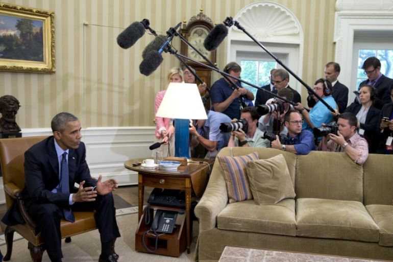 President Barack Obama speaks to media as he meets with Attorney General Loretta Lynch in the Oval Office of the White House in Washington, Friday, May 29, 2015. The president said a "handful of senators" are the only thing standing in the way of an extension of key Patriot Act provisions before they expire at midnight Sunday. (AP Photo/Carolyn Kaster)
