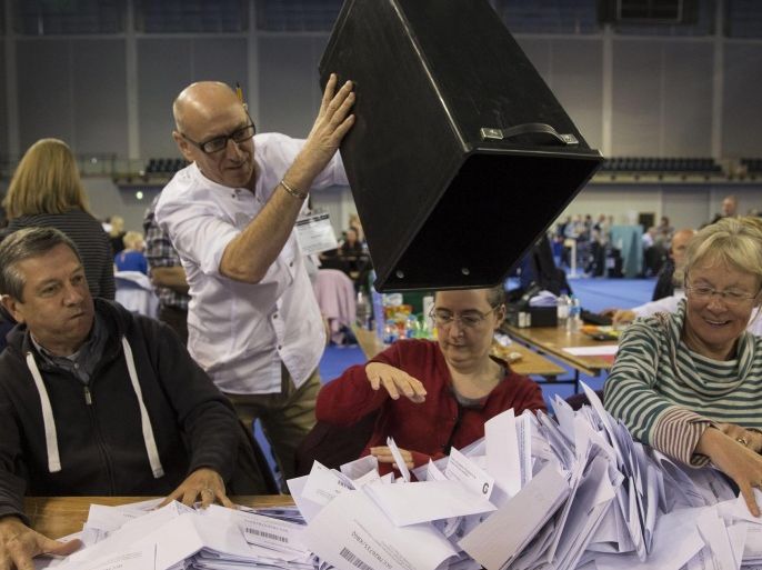 Election officials count ballot papers at Emirates Arena in Glasgow, Britain, 08 May 2015. British Prime Minister David Cameron's Conservatives are expected to win 316 seats in parliamentary elections on 07 May, according to exit polls, an outcome that would allow the party to form another coalition government with the Liberal Democrats.