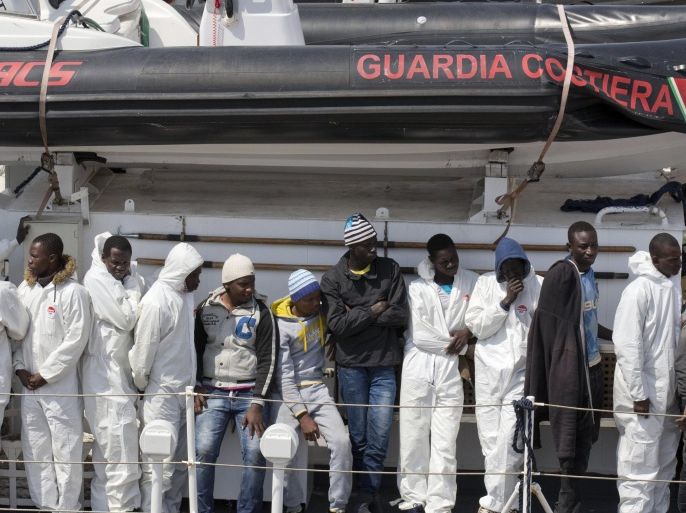 Migrants wait to disembark from the Italian Coast Guard ship Fiorillo, at the Catania harbor, Sicily, southern Italy, Friday, April 24, 2015. The European Union's border agency Frontex is to send its ships further into the Mediterranean Sea in response to a deadly exodus of migrants leaving Libya. (AP Photo/Alessandra Tarantino)