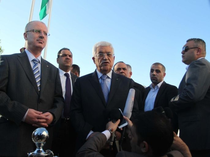 RAMALLAH, WEST BANK - OCTOBER 04: Palestinian President Mahmoud Abbas (C) with the Palestinian Prime Minister Rami Hamdallah (L), makes a statement to the press after his visit to the Mausoleum of the Yasser Arafat, Palestinian leader deceased in the year of 2004, during his visit due to Eid al-Adha (One of the two important feast of Muslims) in Ramallah, West Bank on October 04, 2014.